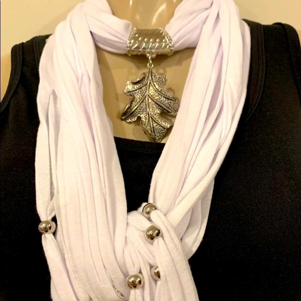 New white scarf with silver leaf charm and fringe